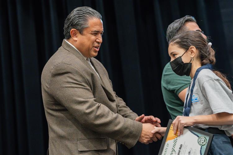 Dr. Hammond shaking hands with one of many students during the TEAMS Celebration Ceremony